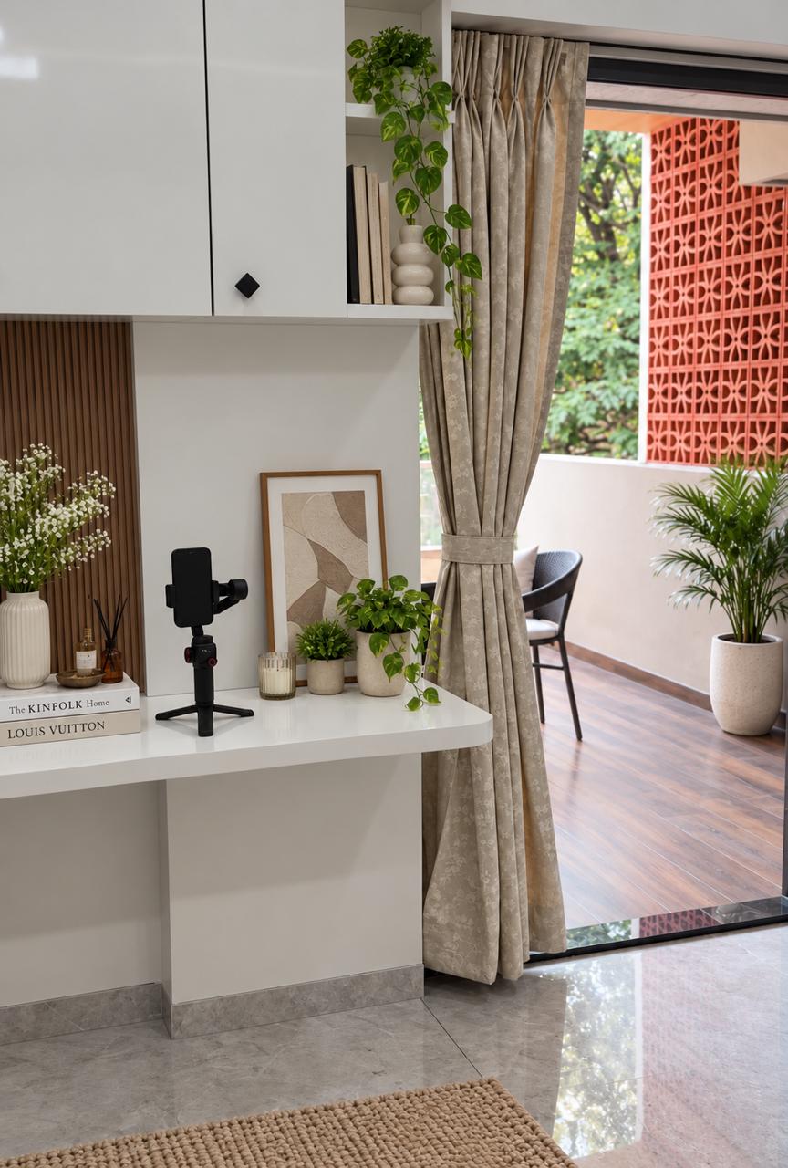Balcony adjoining desk setup with patterned terracotta breeze blocks